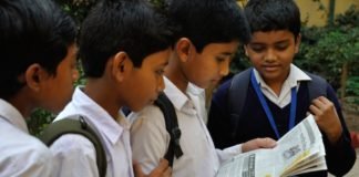 Only 32% urban & 65% non-metro consumers getting newspapers at home Students reading a newspaper together in Murshidabad