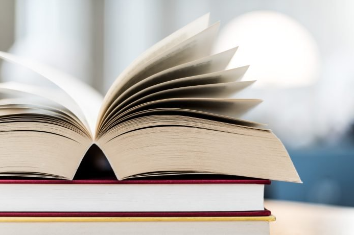 Open book lying on the table in the library An update on commercial print capacity creation in FY24-25